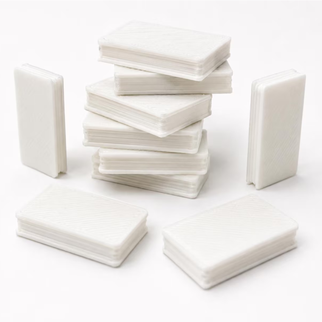 White rectangular card-like pieces arranged in stacks on a clean white background.