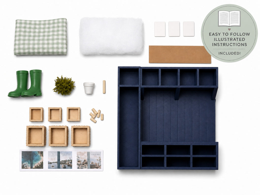 A flat-lay product presentation of a miniature dollhouse furniture set, featuring a large navy blue storage organizer, a green and white gingham blanket, a white plush cushion, green rain boots, wooden boxes, and various accessories, all arranged on a clean white background with an instruction booklet and a badge.